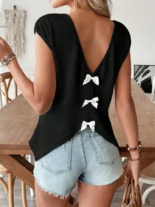 Back view of black V-neck T-shirt featuring three decorative white bows on textured fabric