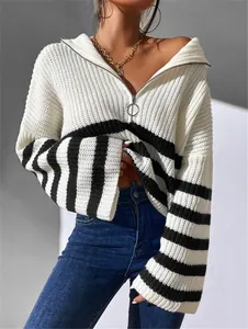 Detail view of women's white striped knit sweater featuring a quarter-zip ring puller.