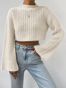 Detail of cream cropped knit sweater featuring bell sleeves and a chic high-neck design.