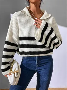 Close-up detail of the knit texture on this black and white striped zip-up sweater.