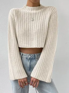 Detail view of a cream knit cropped sweater featuring wide flare sleeves and a mock neck.