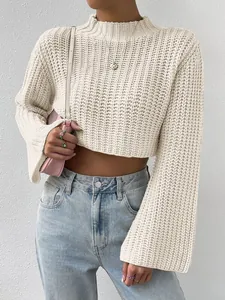 Detail of cropped mock neck knit sweater with stylish bell sleeves and chunky texture