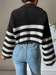 Back view of a black and white striped cropped knit sweater with mock neck detail