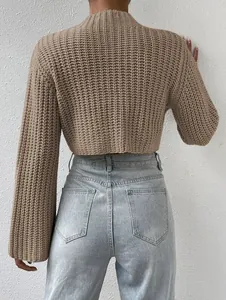 Detailed back view of a chunky knit beige cropped sweater featuring wide flared sleeves