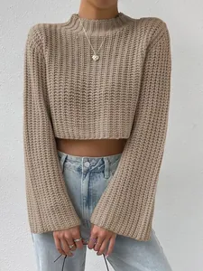 Close-up of stylish beige cropped knit sweater featuring flared bell sleeves on a model