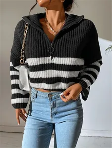 Detail view of women's black and white striped ribbed sweater with ring zipper