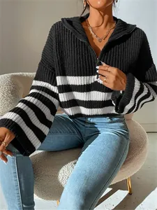 Close-up of black and white striped half-zip ribbed knit sweater with standing collar