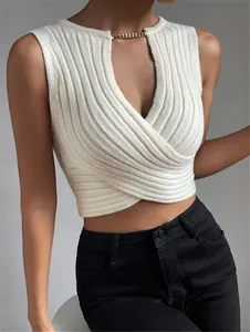 Detailansicht des weißen Stricktops mit Wickeldesign und goldener Kettendekoration am Hals.