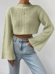 Detailed view of sage green chunky knit sweater featuring mock neck and wide flare sleeves