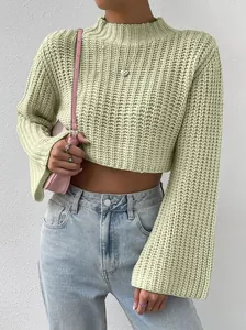 Detailed view of sage green cropped knit sweater with flared sleeves and mock neck