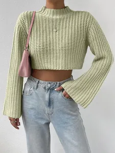 Detail view of mint green cropped knit pullover featuring mock neck and flared bell sleeves