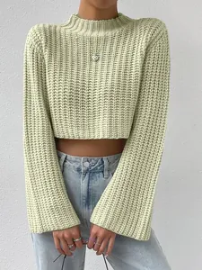 Close-up of mint green cropped knit sweater featuring flare sleeves and a mock neck.