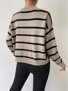 Detailed back view of a loose round neck striped knitted pullover sweater in tan and black