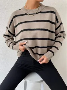 Detailed view of loose beige and black striped knit sweater with round neck