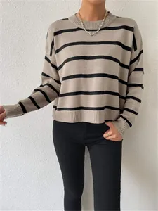 Close-up detail of a casual loose fit crewneck striped knit pullover sweater for women