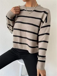 Detailed view of loose-fitting crewneck striped knit sweater in apricot and black