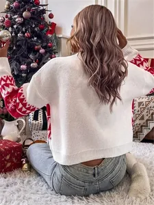 Back view of a white knitted Christmas sweater with red festive patterns on sleeves