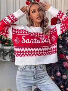Detail view of red and white knitted Christmas sweater with Santa Baby festive pattern.