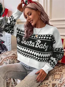 Close-up view of women's black and white Christmas sweater featuring 'Santa Baby' knit design.