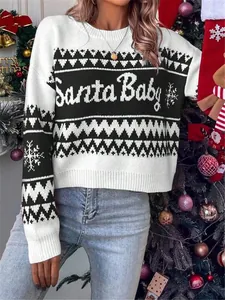 Close-up detail of festive Santa Baby knit sweater with snowflake print and round neck