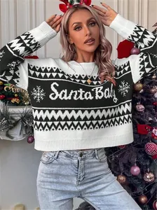 Macro view of Santa Baby knitted pattern and snowflake details on Christmas sweater