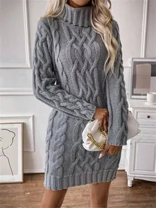 Detailed view of gray cable-knit turtleneck sweater dress with elegant texture.
