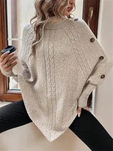 Dettaglio maglione a trecce beige dolcevita con bottoni sulle spalle e maniche a pipistrello