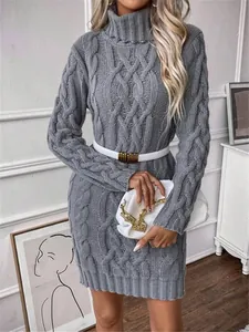 Detailed view of a grey cable knit turtle neck sweater dress with a white belt.