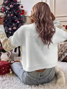 Detailed rear view of a white loose-fit knitted Christmas sweater in a festive home setting