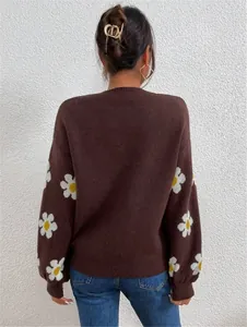 Vue arrière d'un pull en maille marron ample avec des motifs de marguerites blanches.