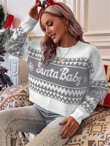 Detailed macro shot of festive Santa Baby text on white and gray knitted sweater