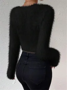 Back view of a black fuzzy cropped sweater for women, featuring soft hairy texture