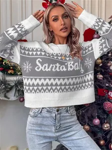 Loose Christmas knit sweater with Santa Baby pattern and snowflakes shown on a model