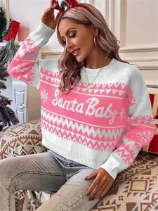Festive pink and white knit sweater with Santa Baby text in a cozy holiday setting