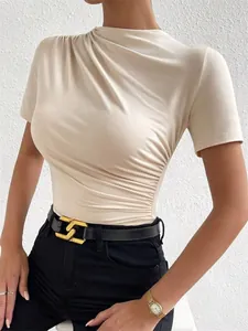 Close-up of elegant beige ruched short sleeve bodysuit with stylish gathering details on waist