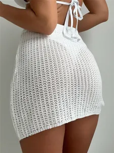 Detailed macro view of white crochet knit beach skirt with delicate hollow-out pattern