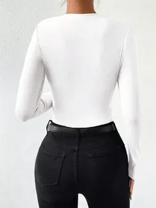 Detailed back view of a white slim-fit long-sleeved bodysuit for women with black jeans