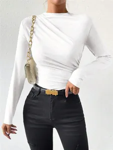 Close-up of a white long sleeve bodysuit featuring an elegant pleated shoulder design