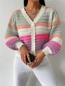 Close-up detail of color-block knit cardigan featuring rainbow stripes and lantern sleeves.