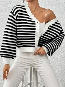 Close-up of a women's black and white striped knit cardigan with lantern sleeves and buttons.