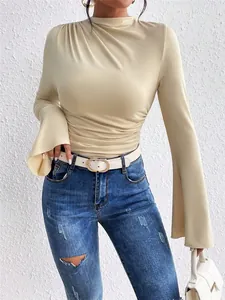 Detail view of women's beige mock neck top with elegant ruched design and stylish flare sleeves
