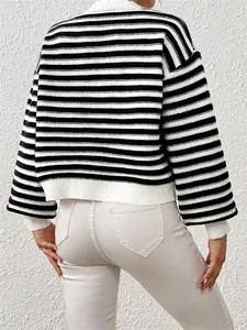 Back view of a black and white striped knit sweater with lantern sleeves and textured knit.