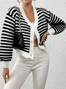Detail view of a black and white striped knitted cardigan with lantern sleeves and V-neckline