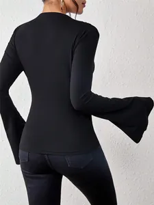 Back view detail of a slim-fit black long sleeve T-shirt with dramatic flare sleeves