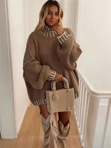 Detail of oversized high-neck sweater with contrast trim and matching handbag