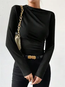 Detail view of black long-sleeve bodysuit featuring elegant ruched texture