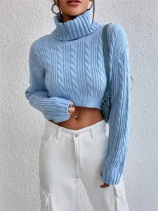 Close-up detail of women's blue turtleneck cable-knit cropped sweater showing fit