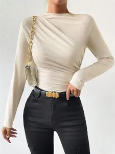 Detail view of a slim fit beige ruched long sleeve bodysuit with elegant draped neckline.
