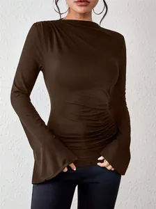 Detail view of slim fit brown mock neck top with ruched bodice and flare sleeves