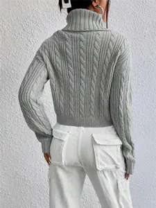 Detailed back view of a grey cable-knit cropped turtleneck sweater with ribbed cuffs